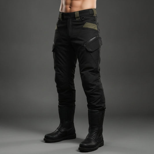 Model wearing black Ride Unmarked RoadVault riding pants with olive panel accents and riding boots, studio shot on a grey background
